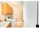 Functional laundry room featuring modern washer and dryer, built-in cabinetry and utility sink at 10441 Garda Dr, Trinity, FL 34655
