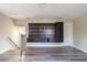 Spacious living room featuring gray wood-look floors and a built-in entertainment center at 10441 Garda Dr, Trinity, FL 34655