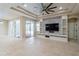 Spacious living room featuring an entertainment center, ceiling fan, and outdoor access at 10441 Garda Dr, Trinity, FL 34655