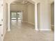Spacious living area featuring tile floors, white columns, and an open layout at 10441 Garda Dr, Trinity, FL 34655