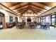 Warmly lit meeting space featuring wood-paneled ceilings and a patterned floor at 10441 Garda Dr, Trinity, FL 34655