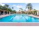 Fantastic community pool with lap lanes, decorative structures, brick deck and comfortable lounge seating at 10441 Garda Dr, Trinity, FL 34655