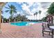 Enjoy the community pool with brick deck, ample lounge seating, and beautiful palm tree views at 10441 Garda Dr, Trinity, FL 34655
