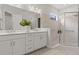 Bathroom with double vanity, walk-in shower, and neutral tile at 10693 Calluna Dr, Odessa, FL 33556
