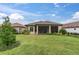 Spacious backyard with screened lanai and grassy area at 10693 Calluna Dr, Odessa, FL 33556