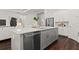 Modern kitchen with a large island, stainless steel appliances, and white cabinets at 10693 Calluna Dr, Odessa, FL 33556