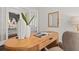 Home office featuring a light wood desk and open floor plan at 10693 Calluna Dr, Odessa, FL 33556