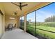 Screened porch with ceiling fans and a view of the backyard at 10693 Calluna Dr, Odessa, FL 33556