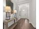 Bright entryway with hardwood floors, light walls and a console table at 10693 Calluna Dr, Odessa, FL 33556