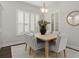 Bright dining room with light gray chairs and wooden table at 10693 Calluna Dr, Odessa, FL 33556