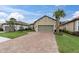 Two-story house with a gray garage door and a brick driveway at 10693 Calluna Dr, Odessa, FL 33556