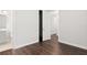 Bedroom with dark wood-look flooring and access to a bathroom and closet at 10693 Calluna Dr, Odessa, FL 33556