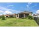 Large backyard featuring a screened patio and lush lawn at 10693 Calluna Dr, Odessa, FL 33556