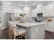 Modern kitchen with white cabinets, a large island, and stainless steel appliances at 10693 Calluna Dr, Odessa, FL 33556