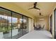 Screened porch with sliding glass doors, ceiling fans, and outdoor furniture at 10693 Calluna Dr, Odessa, FL 33556