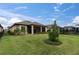 Backyard view showing a home with a screened porch and a well-maintained lawn at 10693 Calluna Dr, Odessa, FL 33556