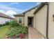 Front entry with a walkway, landscaping, and a light fixture at 10693 Calluna Dr, Odessa, FL 33556
