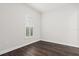 Bedroom featuring dark wood-look floors and a window with plantation shutters at 10693 Calluna Dr, Odessa, FL 33556