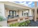 Covered front porch with seating and view of trees at 203 S Spring Blvd, Tarpon Springs, FL 34689