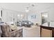 Light-filled living area featuring a sectional sofa and wood-look floors at 203 S Spring Blvd, Tarpon Springs, FL 34689