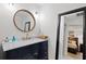 Elegant bathroom with a navy vanity and a marble countertop at 203 S Spring Blvd, Tarpon Springs, FL 34689
