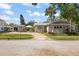 Two-story house with a driveway and landscaping at 203 S Spring Blvd, Tarpon Springs, FL 34689