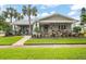 Charming craftsman home with a front porch and landscaping at 203 S Spring Blvd, Tarpon Springs, FL 34689