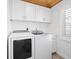 Laundry room with white cabinets, washer, and dryer at 203 S Spring Blvd, Tarpon Springs, FL 34689