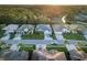Aerial view of a residential street with houses, solar panels, and lush greenery at 2533 Wood Pointe Dr, Holiday, FL 34691