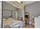 Spacious bedroom with a four-poster bed and TV at 2533 Wood Pointe Dr, Holiday, FL 34691