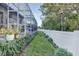 Landscaped backyard with fence and screened patio at 2533 Wood Pointe Dr, Holiday, FL 34691