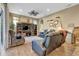 Spacious living room with hardwood floors, comfortable seating, and a large TV at 2533 Wood Pointe Dr, Holiday, FL 34691