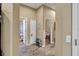 Long hallway with access to bedrooms, laundry, and stairs at 2533 Wood Pointe Dr, Holiday, FL 34691