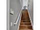 Elegant staircase with wood flooring and white railings at 2533 Wood Pointe Dr, Holiday, FL 34691