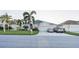 Two-car garage home with palm trees and landscaping at 2533 Wood Pointe Dr, Holiday, FL 34691
