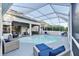 Inviting pool area with covered patio and comfortable seating at 2533 Wood Pointe Dr, Holiday, FL 34691