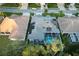 An aerial view of a house with solar panels and a pool at 2533 Wood Pointe Dr, Holiday, FL 34691