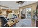 Relaxing living room with pool view, hardwood floors, and comfortable seating at 2533 Wood Pointe Dr, Holiday, FL 34691