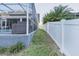 Landscaped backyard with fence and pool at 2533 Wood Pointe Dr, Holiday, FL 34691