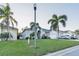 House exterior featuring a two-car garage and palm trees at 2533 Wood Pointe Dr, Holiday, FL 34691