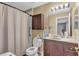 Clean bathroom with dark wood vanity and shower at 2533 Wood Pointe Dr, Holiday, FL 34691