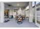 Covered patio with outdoor dining set and grill at 2533 Wood Pointe Dr, Holiday, FL 34691