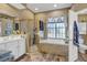 Spacious bathroom with soaking tub, shower, and double vanity at 2533 Wood Pointe Dr, Holiday, FL 34691
