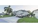 Two-car garage home with palm trees and landscaping at 2533 Wood Pointe Dr, Holiday, FL 34691