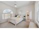 Bright bedroom with white furniture and large window at 3527 Conifer Loop, Spring Hill, FL 34609