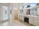 Bathroom with double vanity, toilet, and access to the pool at 3527 Conifer Loop, Spring Hill, FL 34609