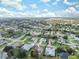 Aerial view of a residential neighborhood with houses, pools, and lush green spaces at 3527 Conifer Loop, Spring Hill, FL 34609