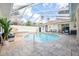 Inviting screened pool and spa with lounge chairs at 3527 Conifer Loop, Spring Hill, FL 34609