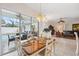 Bright dining room with table set for four, view of pool through sliding glass doors at 3527 Conifer Loop, Spring Hill, FL 34609