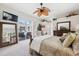 Primary bedroom with king bed, TV, and view of the pool through sliding doors at 3527 Conifer Loop, Spring Hill, FL 34609